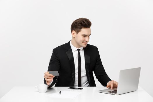 Young businessman with notebook and credit card isolated over white background