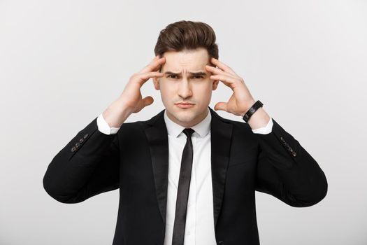 Business Concept: Young businessman with holding hands on head with headache facial expression isolated over white background