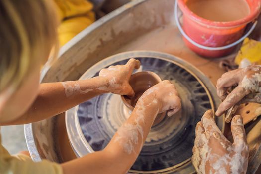 Father and son doing ceramic pot in pottery workshop