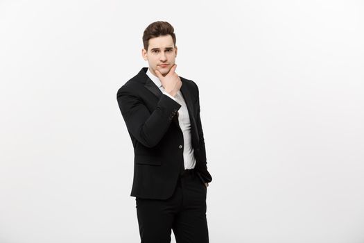 Young handsome man in black suit and glasses looking at copy-space thinking or dreaming isolated over white background