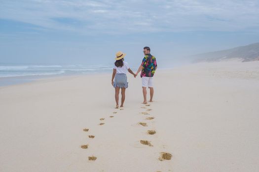 Man and woman walking at the beach De Hoop Nature reserve South Africa Western Cape, beach of south africa with the white dunes at the de hoop nature reserve which is part of the garden route