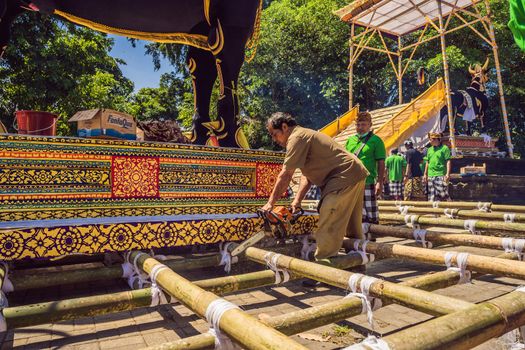 Ubud, Bali, Indonesia - April 22, 2019 : Royal cremation ceremony prepation. Balinese hindus religion procession. Bade and Lembu Black Bull symbol of transportation for the spirit to the heaven