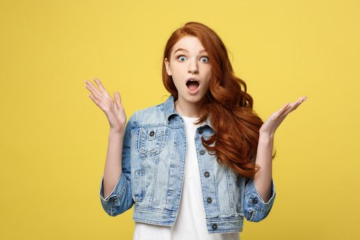 Close up Portrait amaze young beautiful attractive redhair girl shocking with something. Isolated on Bright Yellow Background. Copy space.