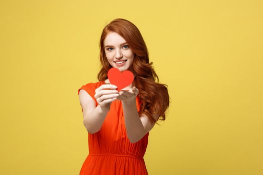 Portrait of happy romantic young caucasian girl with red paper heart-shaped postcard, romantic wishes, Valentine day celebration, love concept