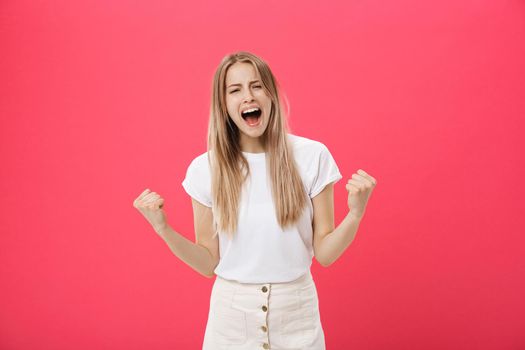 Young woman getting angry ,crazy and shouting isolated on a pink background.