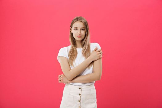 Trendy young female wearing casual clothes posing over pink background