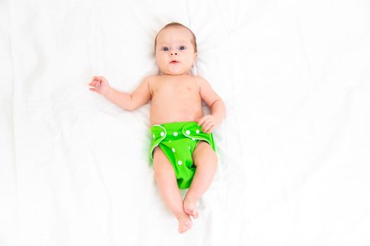 Reusable diaper on the baby copy space . An article about reusable diapers. Saving on diapers. Concern for the environment. Eco-products.
