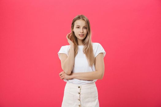 Trendy young female wearing casual clothes posing over pink background