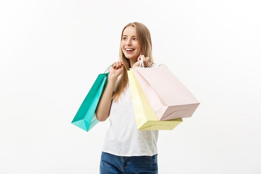 Shopping and Lifestyle Concept: Young happy summer shopping woman smiling and holding shopping bags isolated on white background