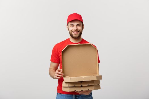 Pizza delivery concept. Young boy is delivering and showing pizza boxs in boxes. Isolated on white background
