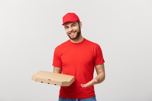 Delivery Concept: Young haapy caucasian Handsome Pizza delivery man holding pizza boxes isolated over grey background