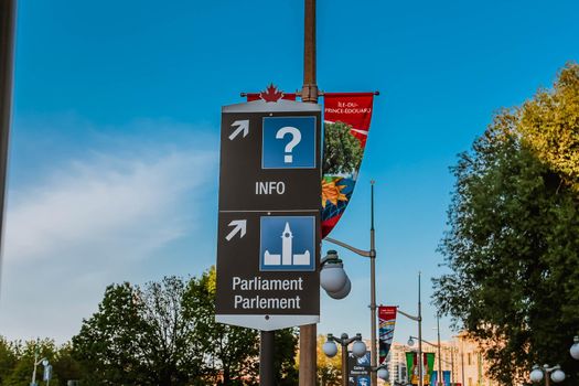 Signs of directions to Info Centre and Parliament Hill seen in downtown Ottawa. Information and Parliament direction sign Canada