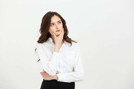 Business Concept: Thoughtful businesswoman with a finger under chin looking. Isolate on white background.