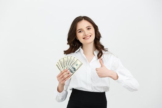 Beautiful young business woman with dollar bills on white background