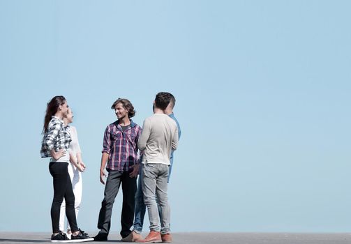 group of students talking while standing outdoors