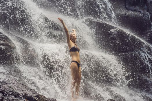 Woman traveler on a waterfall background. Ecotourism concept
