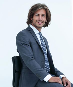 Inviting business man sitting on chair with relaxed attitude