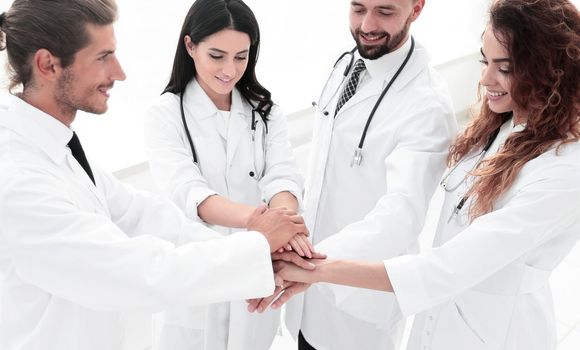 medical team with hands clasped together