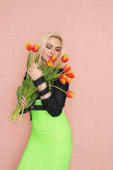 Fashion blonde woman with red tulips