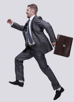side view.cheerful businessman with briefcase stepping forward