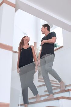 young couple standing on the stairs in their new home.