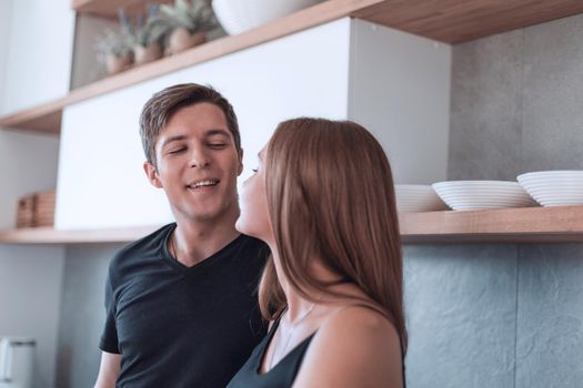 romantic young couple standing in the kitchen