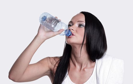 Sporting girl drinking water during exercise