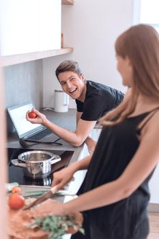 happy young couple cooks in their modern kitchen.