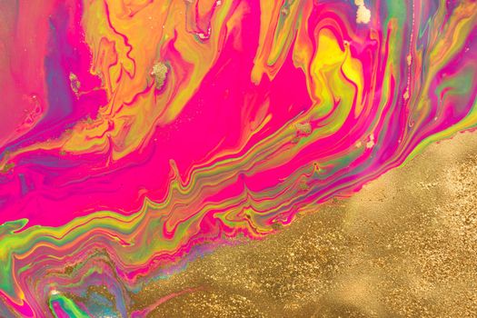 Gold dust spots on liquid fluorescent paints background.