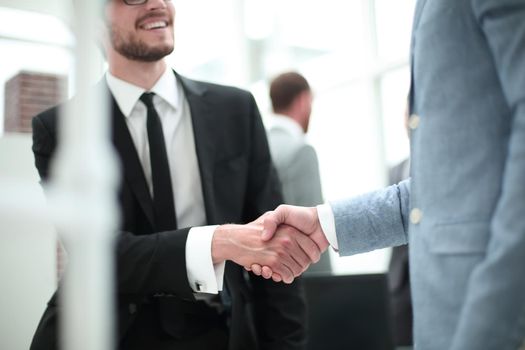 smiling businessman shaking hands with his business partner