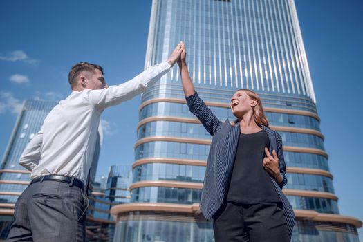 happy business colleagues giving each other a high five
