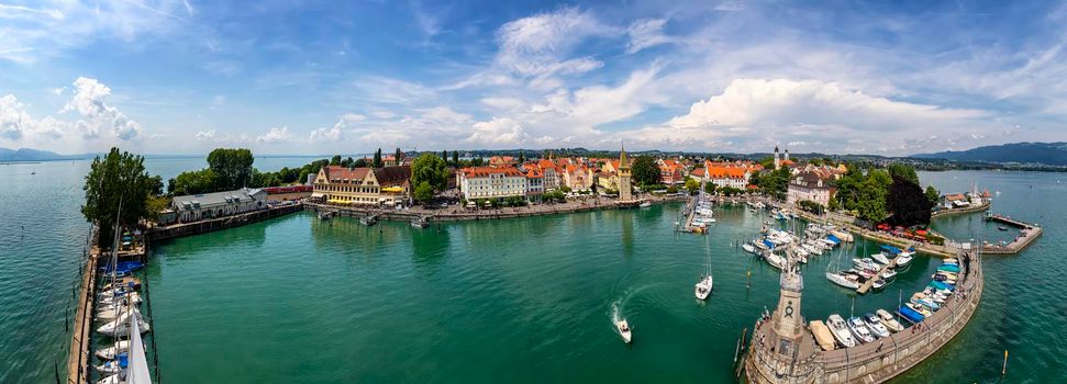 Lindau, Germany - July.21 2019: Amazing panorama of Harbor on Lake Constance with a statue of a lion at the entrance in Lindau, Bavaria, Germany.