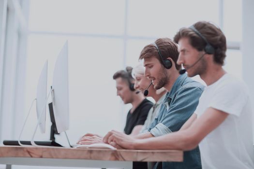group of people in the headset works on personal computers.