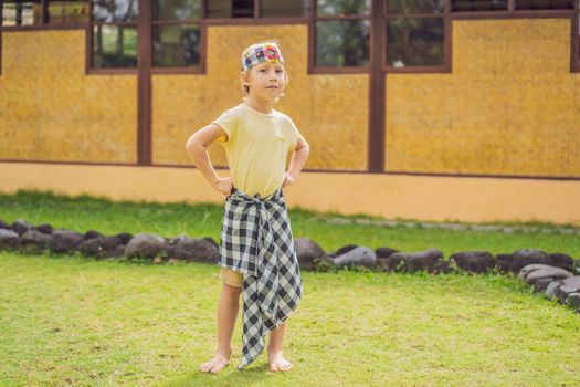 Boy tourist in sarong, national Balinese clothing