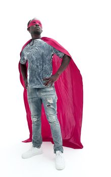 in full growth. confident guy in jeans and a superhero raincoat.