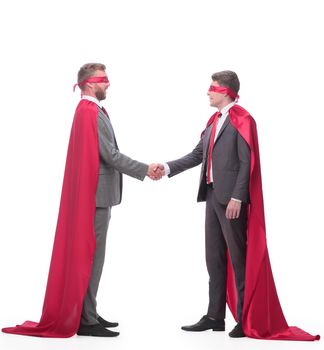 two businessman in superhero capes shake hands