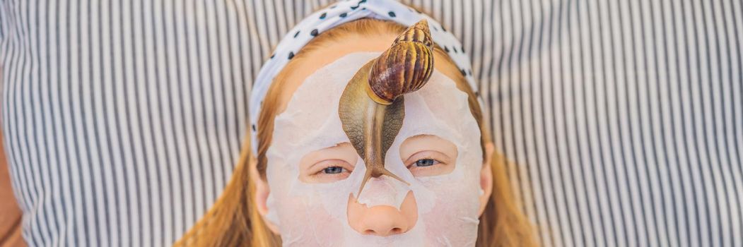 Young woman makes a face mask with snail mucus. Snail crawling on a face mask BANNER, LONG FORMAT