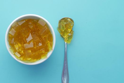 close up of yellow color jelly in a bowl on green
