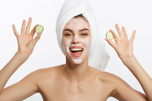 Beauty Portrait Of Smiling Woman With Towel On Head And Slice Of Cucumber In Hand Isolated On White Background.