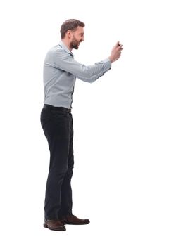 side view. attractive young businessman taking selfie on his smartphone