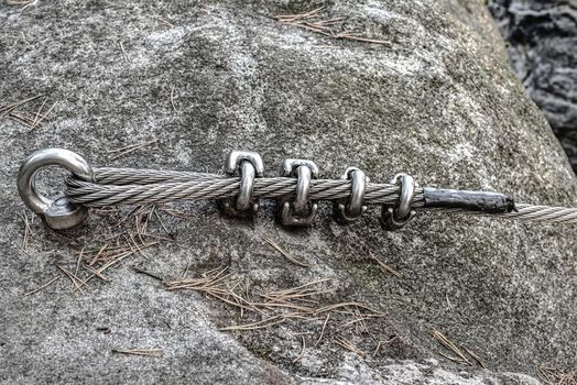 Detail of via ferrata cable attached to stainless rod