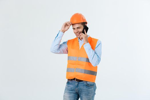Smiling construction engineer posing isolated over grey background