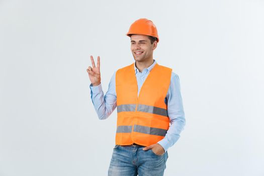 Young workman with helmet happy and counting two with fingers on white background
