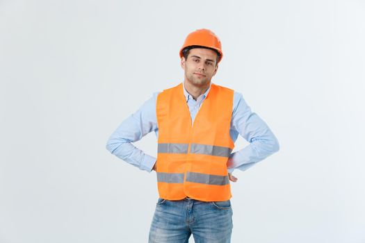 Young man wearing architect outfit and helmet with angry face, negative dislike emotion. Angry and rejection concept