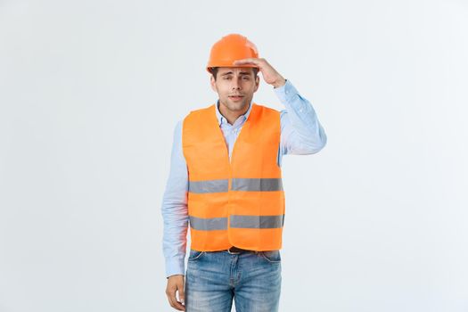 Handsome young engineer man over white background wearing safety helmet with serious face and hand shocked with shame for mistake, expression of fear, scared in silence, secret concept