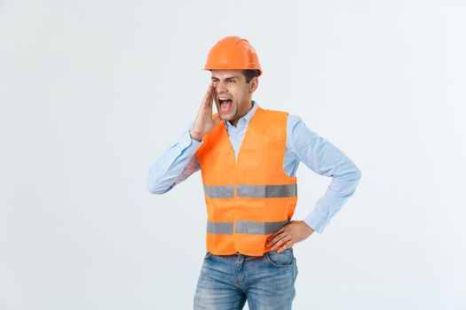 Angry engineer with angry face emotion shouting at someone raising his both hands, isolated on a white background.