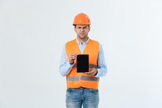 Serious Engineer man holding tablet and checking project , He feel unhappy and serious from project.