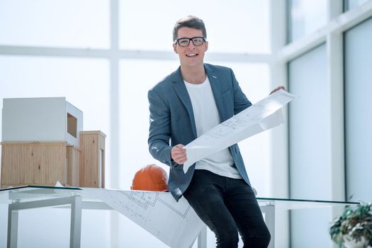 smiling architect with a drawing of a new project.