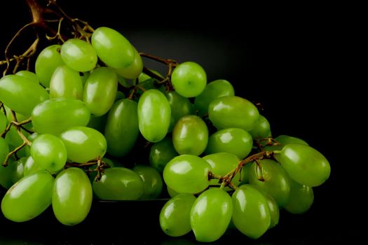 A bunch of table grapes on a black background
