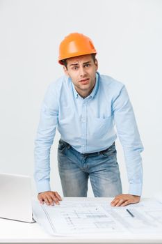 Stressed young constructor having headache or migraine looking exhausted and worried isolated on white background with copy space